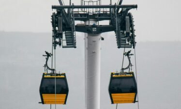 A cable car system with gondolas in a foggy outdoor setting, showcasing industrial design.