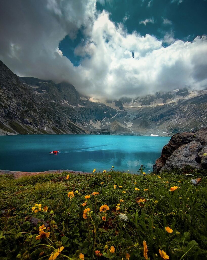 Stunning view of a tranquil lake surrounded by mountains in Kumrat Valley, Pakistan.